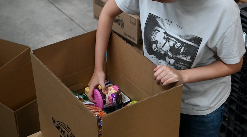 Pictured are volunteers at Shared Harvest Foodbank in Fairfield, Ohio, on Wednesday, July 9, 2025, packaging food in preparation for distribution. The federal cut to Supplemental Nutrition Assistance Program, or SNAP, benefits with the passage of the so-called "One Big Beautiful Bill" approved by Congress and signed by President Donald Trump, organizations like Shared Harvest expect to see an increase in clients as federal food supplies decrease. "Our greatest concern is that we continue in the pattern of reducing food sources, and we continue to see growing numbers of people coming to our network,” said Shared Harvest Executive Director Terry Perdue. “It’s less food and more people needing access to charitable food.” MICHAEL D. PITMAN/STAFF