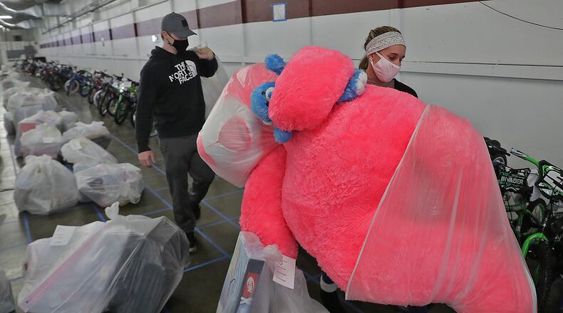 Springfield Salvation Army volunteers collected bags of toys and bicycles from the sea of plastic bags and rows of bikes during the Army's Christmas toy distribution for needy families Thursday at the Clark County Fairgrounds. BILL LACKEY/STAFF