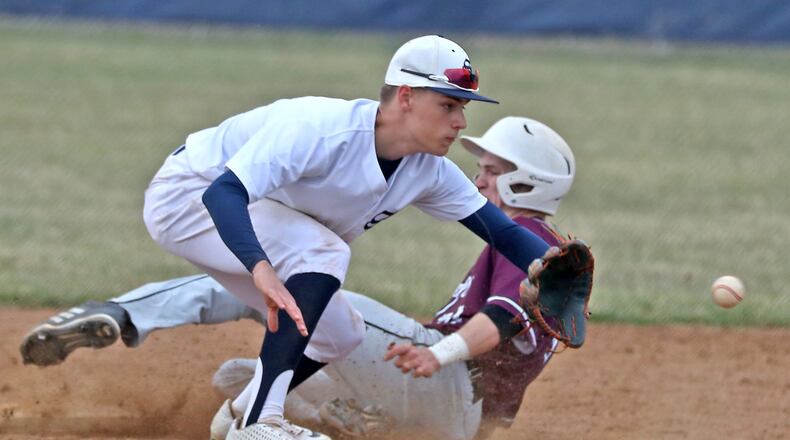 Lebanon’s Matthew Belongia slides safely into second as Springfield shortstop Triston Duncan waits for the throw from home. BILL LACKEY/STAFF