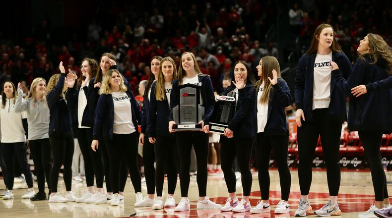 The Dayton volleyball team is honored during a men's basketball game against Rhode Island on Friday, Jan. 28, 2022, at UD Arena. David Jablonski/Staff
