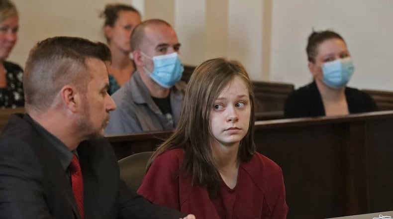 Natasha Ellis, 16, looks at her lawyer before pleading guilty Thursday to the murder and attempted murder of her friend’s parents in New Carlisle last year. BILL LACKEY/STAFF