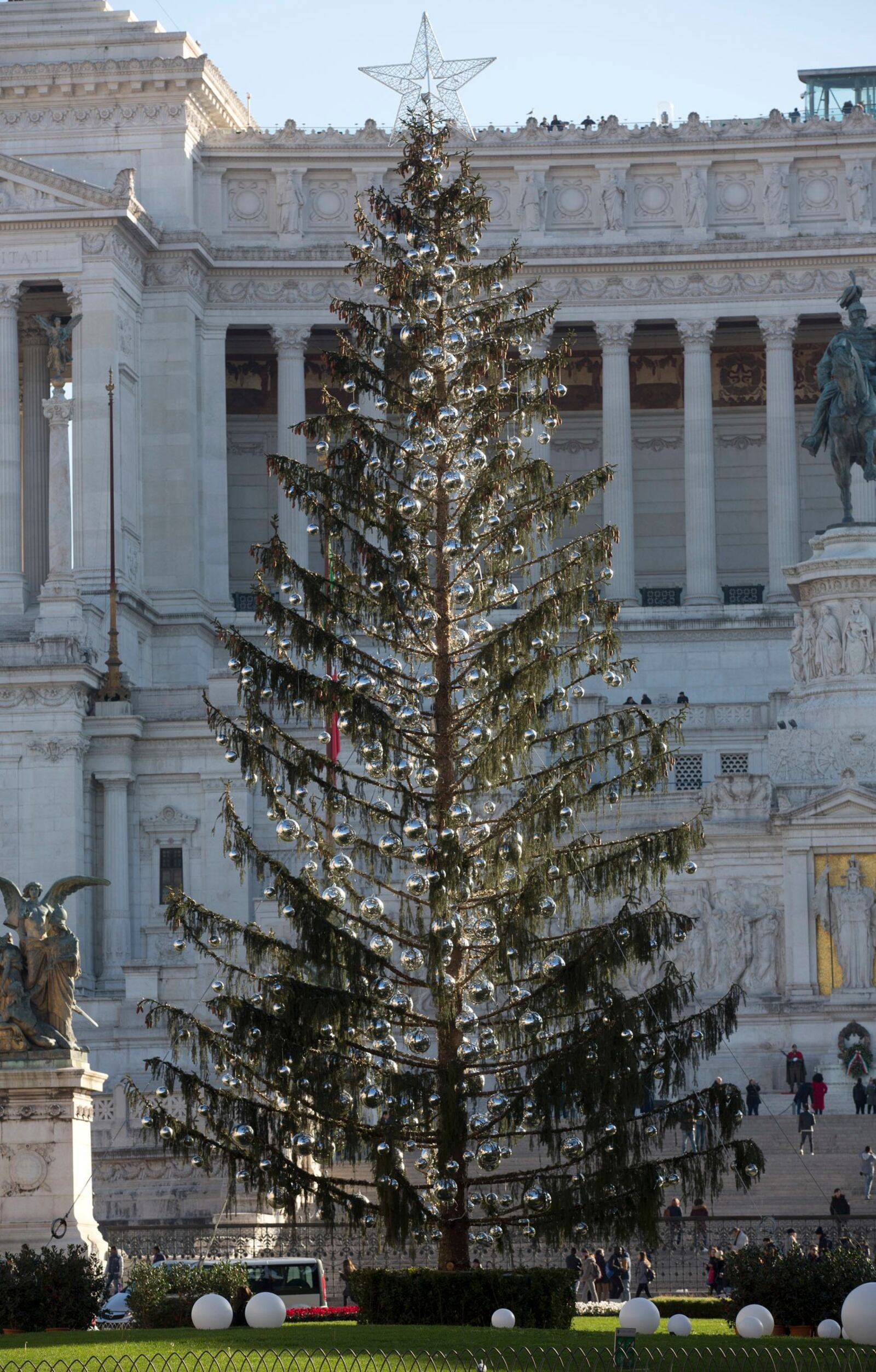 Rome's official Christmas tree stands in front of the Unknown Soldier monument in Piazza Venezia Square. Despite the tree's 600 silver-colored decorative balls, the half-bare branches lend the square a forlorn rather than festive look and critics note that across town, the Vatican's Christmas tree, from Poland, looks healthy.