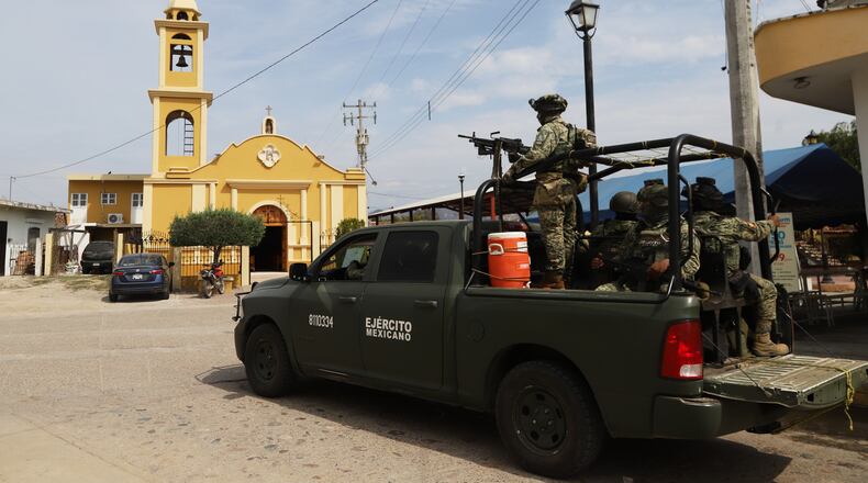 Soldiers stand guard near a church in El Verde, Sinaloa state, Mexico, Monday, Feb. 8, 2026. (AP Photo/Juvencio Villanueva)