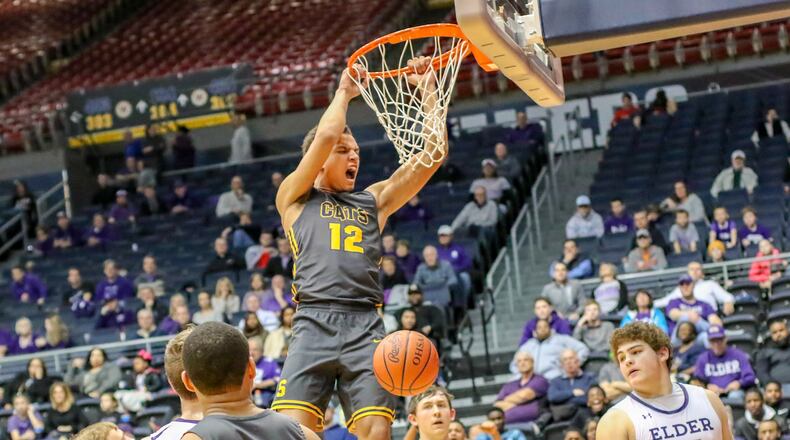 Springfield High School junior Raymans Cole finishes off a dunk during a Division I district final game against Elder on Saturday night at the University of Dayton Arena. The Wildcats won 55-35. CONTRIBUTED PHOTO BY MICHAEL COOPER