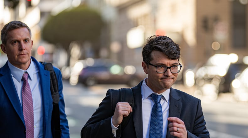 Members of Elon Musk's legal team, including attorney Stephen Broome, left, exit the Phillip Burton Federal Building after representing Elon Musk, in San Francisco, Wednesday, March 4, 2026. (Dan Hernandez/San Francisco Chronicle via AP)