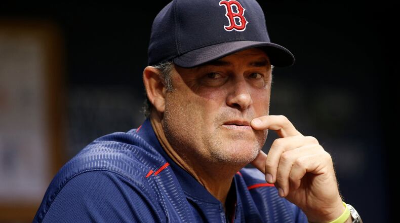 ST. PETERSBURG, FL - SEPTEMBER 15: Manager John Farrell #53 of the Boston Red Sox looks on from the dugout during the third inning of a game against the Tampa Bay Rays on September 15, 2017 at Tropicana Field in St. Petersburg, Florida. (Photo by Brian Blanco/Getty Images)