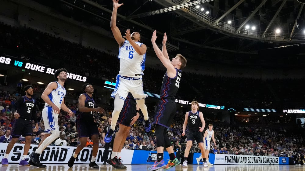 Duke forward Maliq Brown (6) shoots the ball against TCU guard Tanner Toolson (55) during the first half in the second round of the NCAA college basketball tournament, Saturday, March 21, 2026, in Greenville, S.C. (AP Photo/Brynn Anderson)
