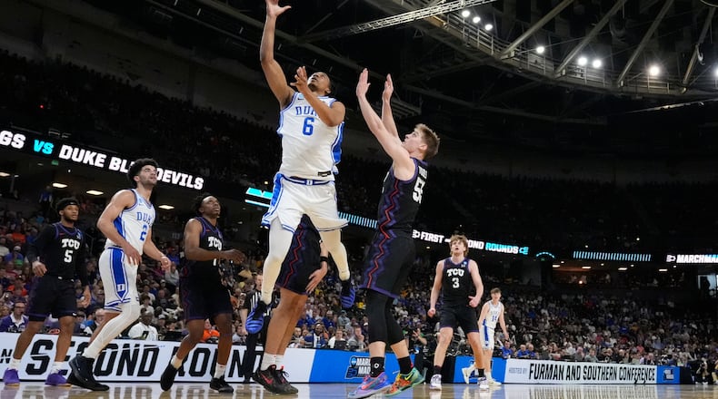 Duke forward Maliq Brown (6) shoots the ball against TCU guard Tanner Toolson (55) during the first half in the second round of the NCAA college basketball tournament, Saturday, March 21, 2026, in Greenville, S.C. (AP Photo/Brynn Anderson)