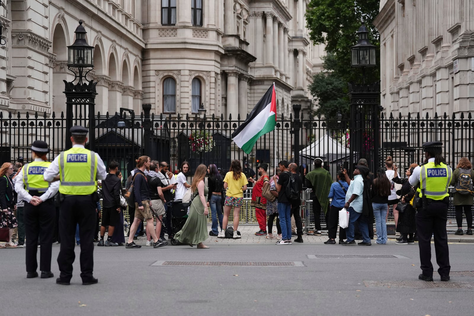 People take part in a protest outside Downing Street in London, Tuesday July 29, 2025, as Prime Minister Keir Starmer gathered senior ministers for an urgent Cabinet meeting on Gaza. (Jonathan Brady/PA via AP)