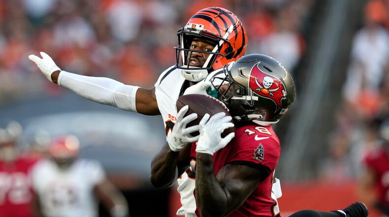 Tampa Bay Buccaneers wide receiver Rakim Jarrett (18) makes a catch as he is defended by Cincinnati Bengals cornerback Dax Hill in the first half of an NFL preseason football game Saturday, Aug. 10, 2024, in Cincinnati. (AP Photo/Carolyn Kaster)