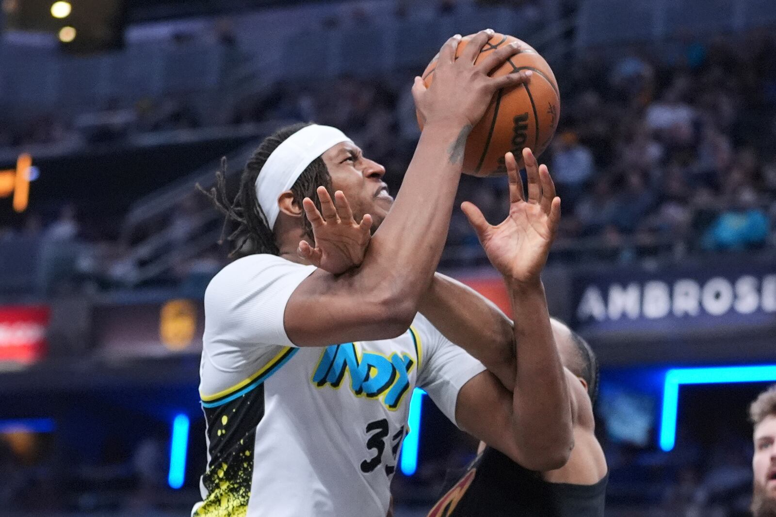 Indiana Pacers center Myles Turner (33) is fouled by Cleveland Cavaliers forward Isaac Okoro (35) during the second half of an NBA basketball game in Indianapolis, Thursday, April 10, 2025. (AP Photo/Michael Conroy)