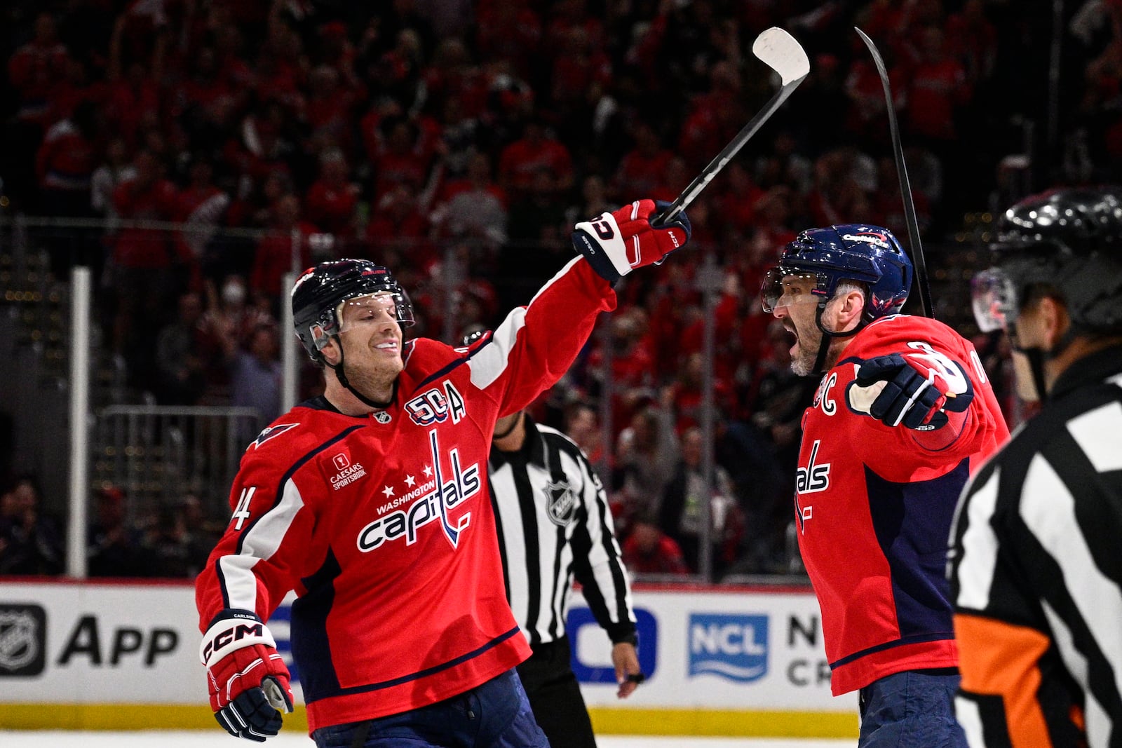 Washington Capitals left wing Alex Ovechkin (8), right, celebrates his goal with defenseman John Carlson, left, in the first period of Game 5 of a first-round NHL hockey playoff series against the Montreal Canadiens, Wednesday, April 30, 2025, in Washington. (AP Photo/Nick Wass)