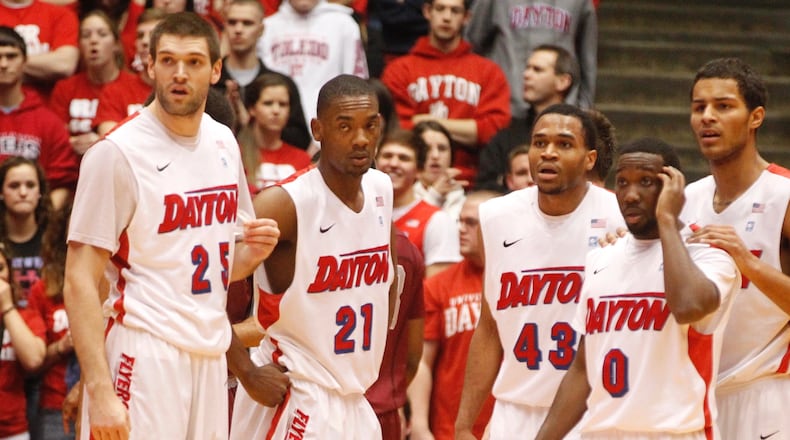 Dayton's Alex Gavrilovic, Dyshawn Pierre, Vee Sanford, Khari Price and Devin Oliver look to the bench for instruction during a game against Saint Joseph's on Wednesday, Jan. 29, 2014, at UD Arena. David Jablonski/Staff