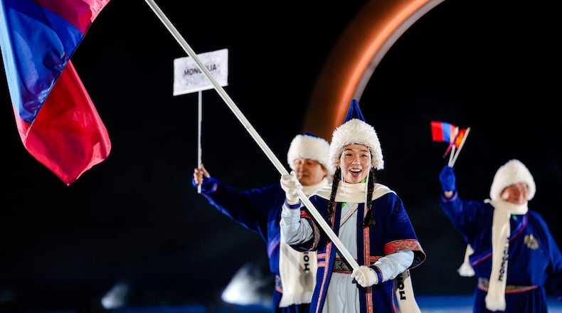 Ariuntungalag Enkhbayar, the flag bearer of Mongolia, takes part in the athletes parade during the Olympic opening ceremony at the 2026 Winter Olympics, in Predazzo, Italy, Friday, Feb. 6, 2026. (AP Photo/Matthias Schrader)
