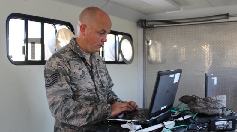 Tech. Sgt. Josh Foley demonstrates communication equipment that will be used in hurricane recovery. JEFF Guerini/STAFF