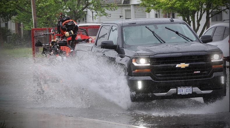 Heavy rainfall on Tuesday, May 4, 2021, caused standing water on roads like on Patterson Road in Dayton. MARSHALL GORBY\STAFF