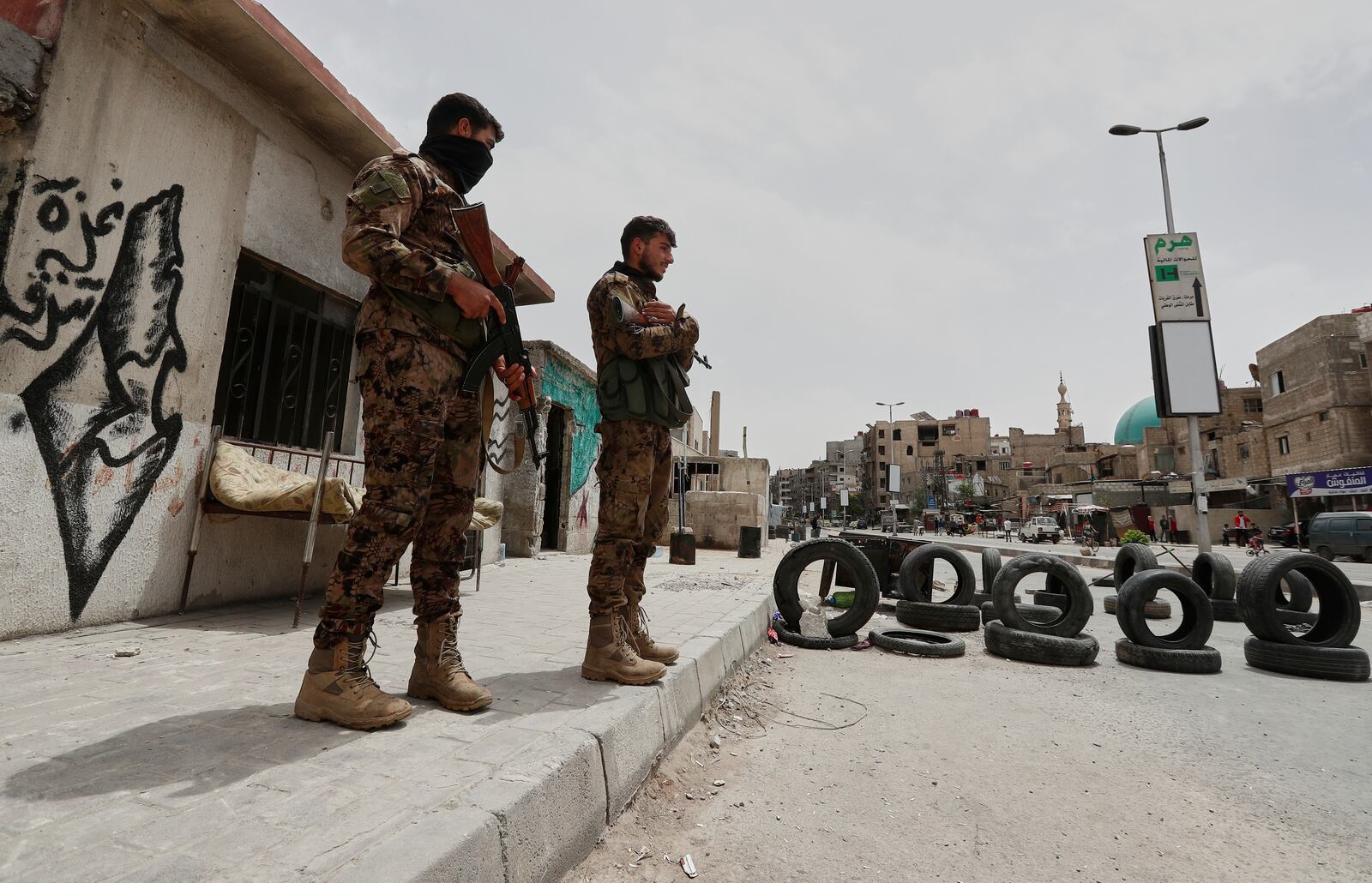 Syrian government security forces stand guard on their checkpointat one of Jaramana suburb entrances, after clashes in the area between members of the minority Druze sect and pro-government fighters, in the southern suburb of Jaramana, Damascus, Syria, Wednesday, April 30, 2025. (AP Photo/Omar Sanadiki)