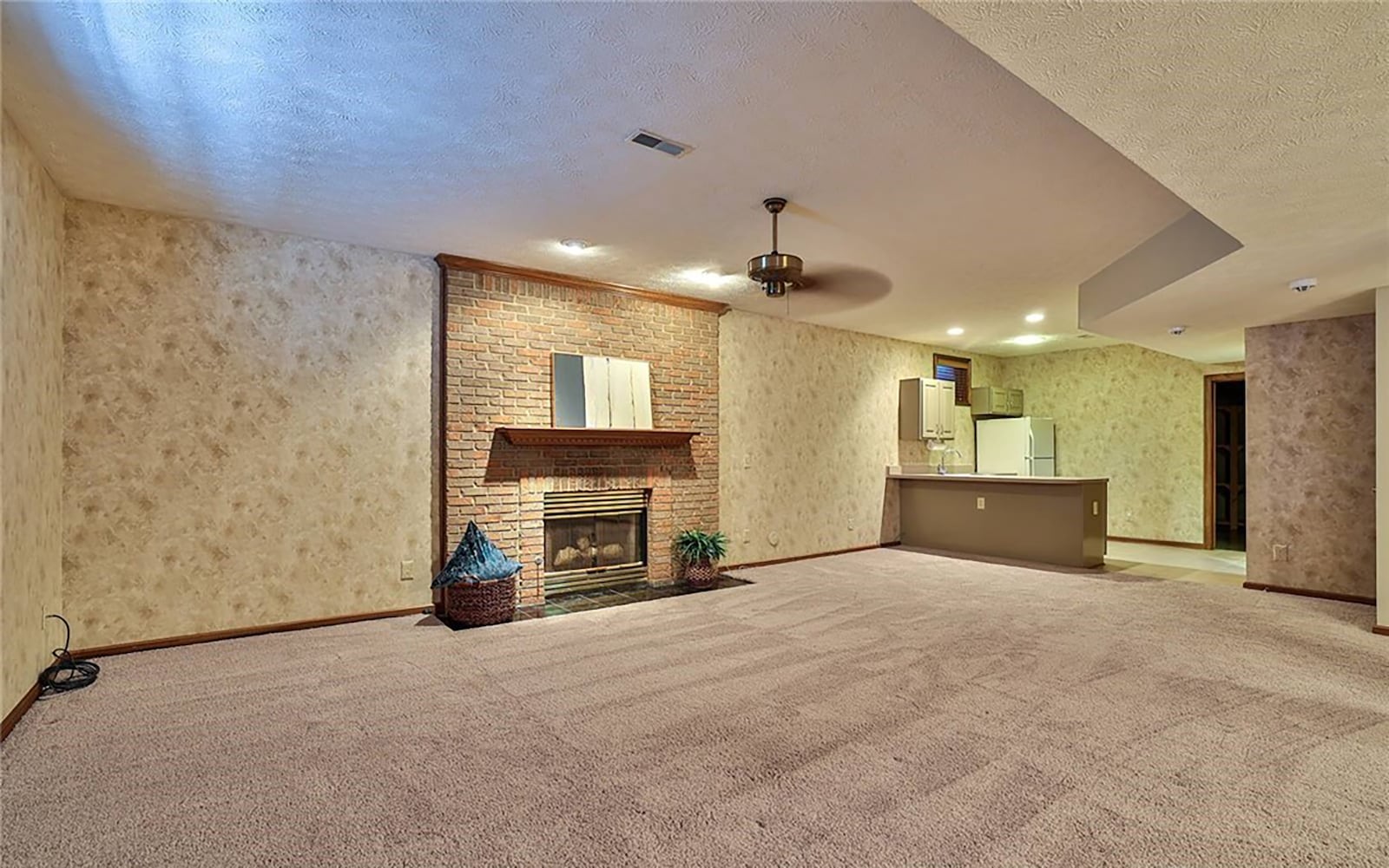 The finished basement has a recreation room with carpeting and a wet bar/kitchenette with refrigerator, cabinets and sink. CONTRIBUTED