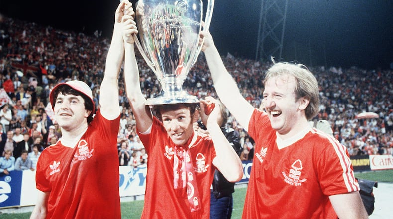 FILE - Nottingham Forest's John Robertson, left, Ian Bowyer, center, and Kenny Burns, right, carry the European Cup in triumph after their 1-0 win against Malmo FF in Munich, Germany, May 30, 1979. (AP Photo, File)