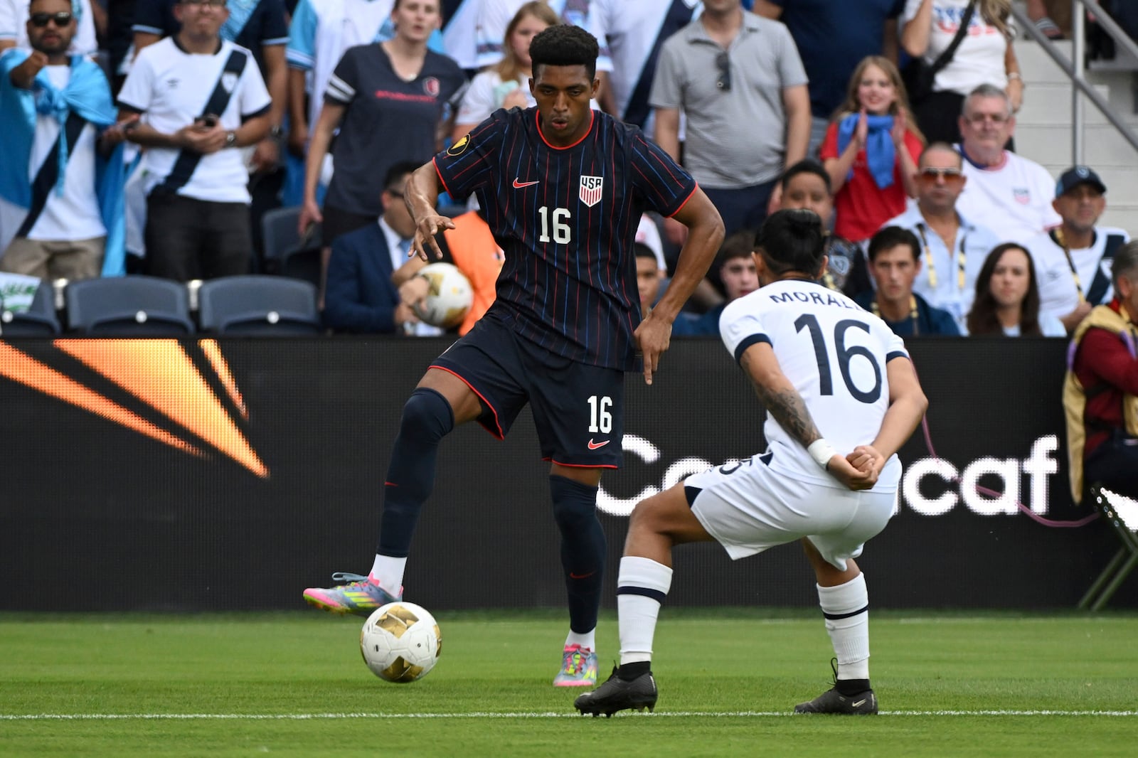 United States defender Alexander Freeman (16) controls the ball as Guatemala defender Jose Morales (16) defends during the first half of a CONCACAF Gold Cup semifinal soccer match, Wednesday, July 2, 2025, in St. Louis. (AP Photo/Connor Hamilton)