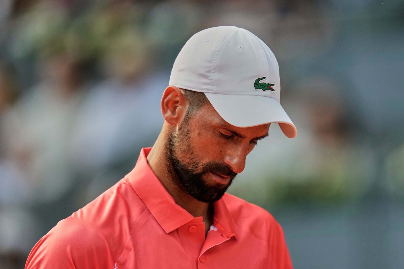 Novak Djokovic of Serbia reacts during his match against Matteo Arnaldi of Italy during the Madrid Open tennis tournament in Madrid, Spain, Saturday, April 26, 2025. (AP Photo/Manu Fernandez)
