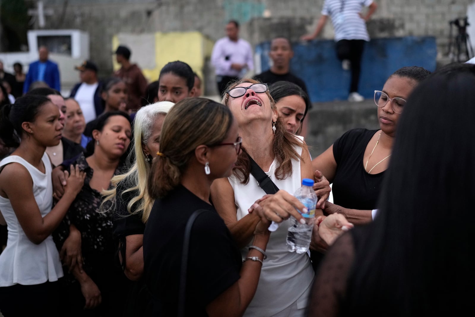 FILE - Family and friends grieve during the burial service for Marilenny Pilarte who died at the Jet Set nightclub when its roof collapsed, in Haina, Dominican Republic, April 10, 2025. (AP Photo/Matias Delacroix, File)