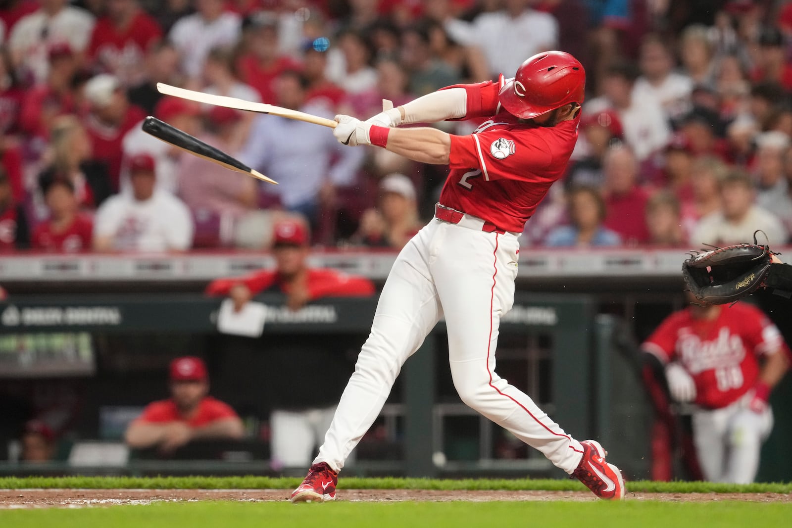 Cincinnati Reds' Gavin Lux holds onto his broken bat after grounding out during the sixth inning of the second baseball game of a doubleheader against the St. Louis Cardinals, Wednesday, April 30, 2025, in Cincinnati. (AP Photo/Jeff Dean)