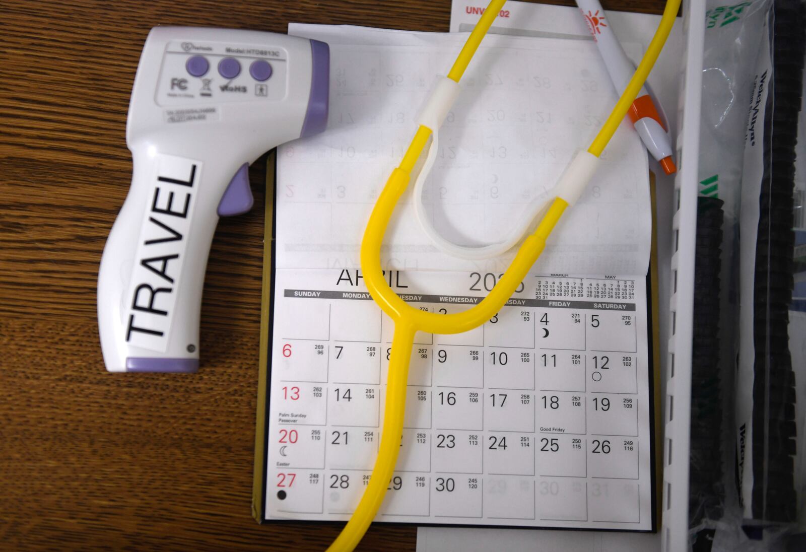 A no-contact thermometer, stethoscope and a calendar are seen at the Andrews County Health Department measles clinic, Tuesday, April 8, 2025, in Andrews, Texas. (AP Photo/Annie Rice)