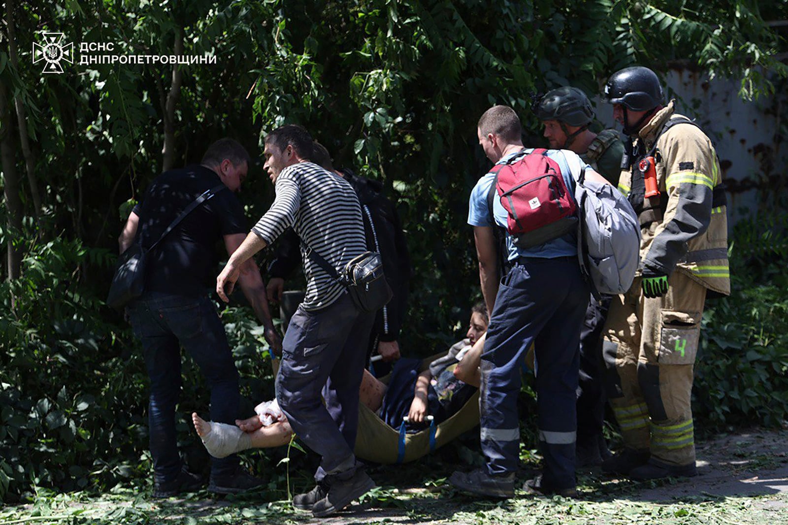In this photo provided by the Ukrainian Emergency Service, rescuers carry an injured civilian following Russia's missile attack in Dnipro, Ukraine, Tuesday, June 24, 2025. (Ukrainian Emergency Service via AP)