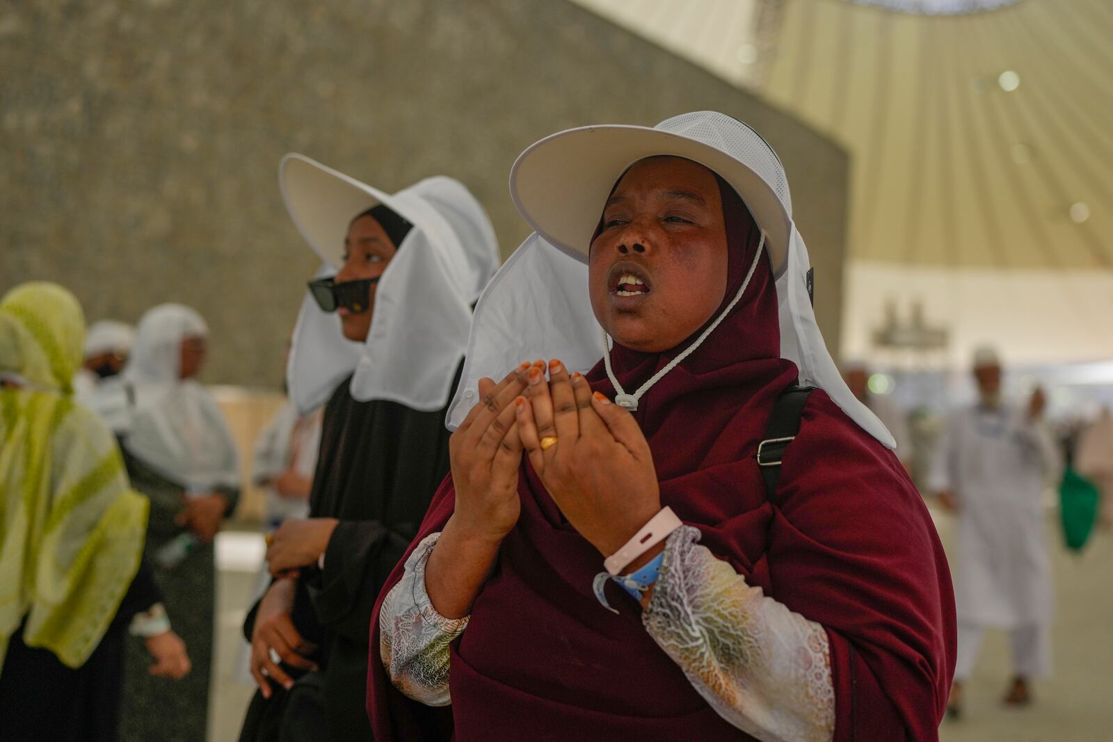 FILE - A pilgrim offer prayers after she cast stones at a pillar in the symbolic stoning of the devil, during the annual Hajj pilgrimage in Mina, near the holy city of Mecca, Saudi Arabia, Tuesday, June 18, 2024. (AP Photo/Rafiq Maqbool, File)