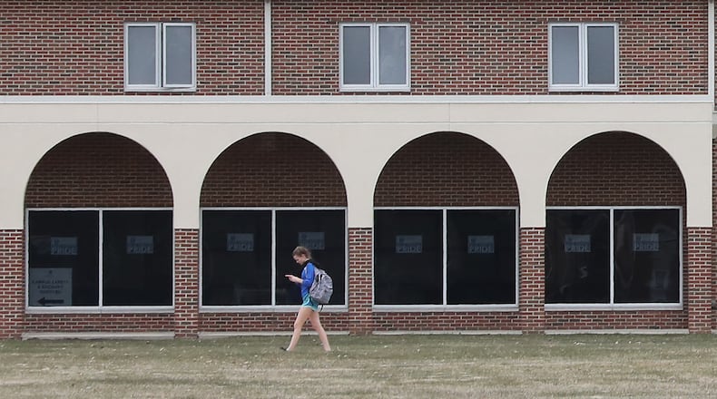 A student at Urbana University walks past the arches on one of the residence hall as she makes her way across on campus Bill Lackey/Staff