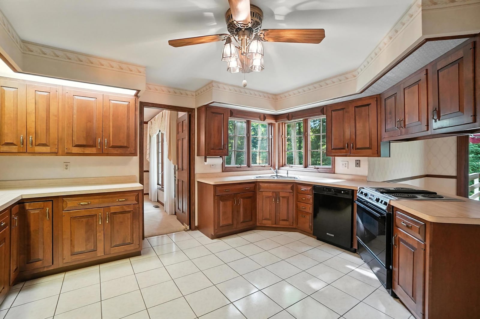 The kitchen has wood cabinets, a ceiling fan, tile flooring and an eat in area. CONTRIBUTED