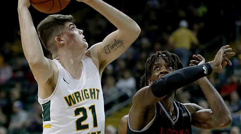 Wright State University forward Grant Basile scores two against IUPUI forward Zo Tyson during their Horizon League game at the Nutter Center in Fairborn Sunday, Feb. 16, 2020. Wright State won 106-66. Contributed photo by E.L. Hubbard