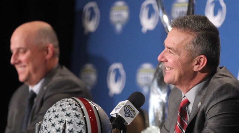 Southern California’s Clay Helton, left, and Ohio State’s Urban Meyer speak at a Cotton Bowl press conference on Thursday, Dec. 28, 2017, at the Omni Dallas Hotel in Dallas, Texas. David Jablonski/Staff