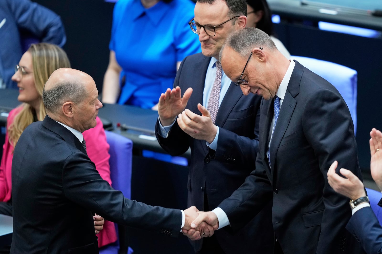 Leader of the Christian Democrats Friedrich Merz is congratulated by outgoing Chancellor Olaf Scholz after being elected new chancellor at the German federal parliament, Bundestag, at the Reichstag building in Berlin, Germany, Tuesday, May 6, 2025. (AP Photo/Ebrahim Noroozi)