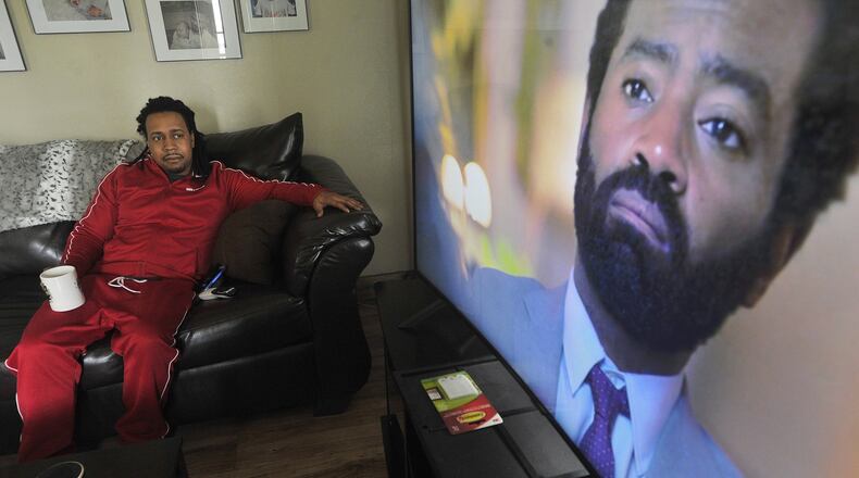 Dion Green, watching TV in his home, said he has gotten more depressed since he’s been unable to leave home because of the COVID-19 pandemic. Green, of Dayton, said he was diagnosed with PTSD after the Memorial Day tornadoes damaged his home and his father died in his arms during the Oregon District mass shooting in August. He has penned a book and is starting a nonprofit for survivors or trauma. MARSHALL GORBYSTAFF