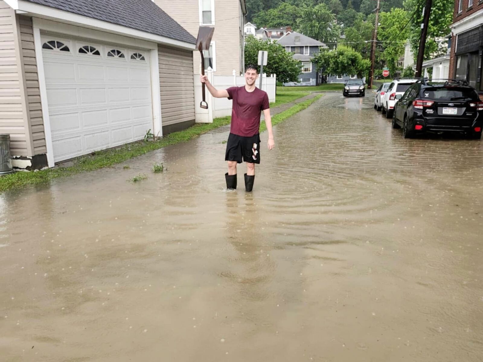 West Virginia resident Walker Holloway stands in several inches of water outside his home in the Edgwood neighborhood following flash flooding in Ohio County, W.Va., Thursday, June 26, 2025. (Jared Thompson/The Intelligencer via AP)