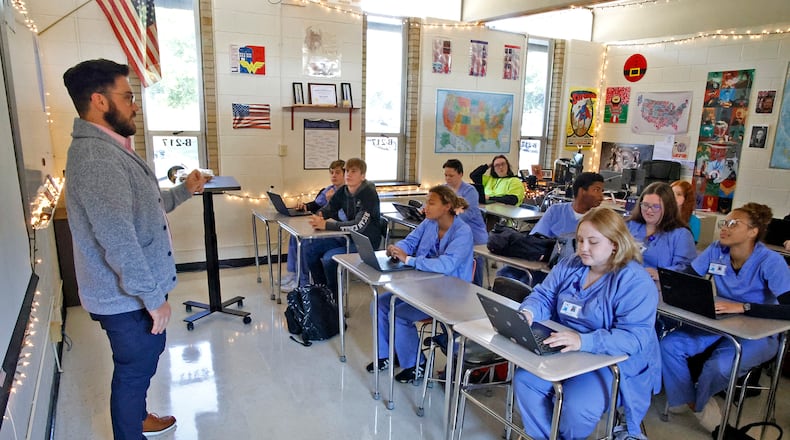 Ross Lunsford teaches his government class in a crowded classroom at the Springfield-Clark Career Technology Center. BILL LACKEY/STAFF