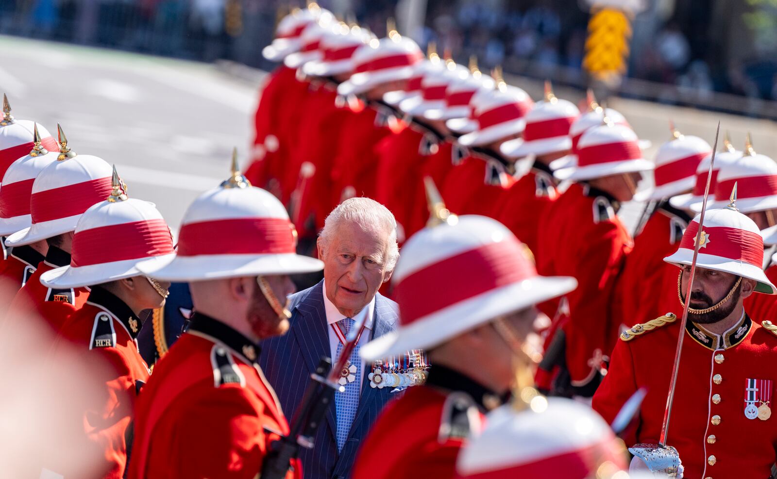 King Charles inspects an honor guard as he arrives in front of the Senate building in Ottawa, Canada, on Tuesday, May 27, 2025. (Christinne Muschi/The Canadian Press via AP)