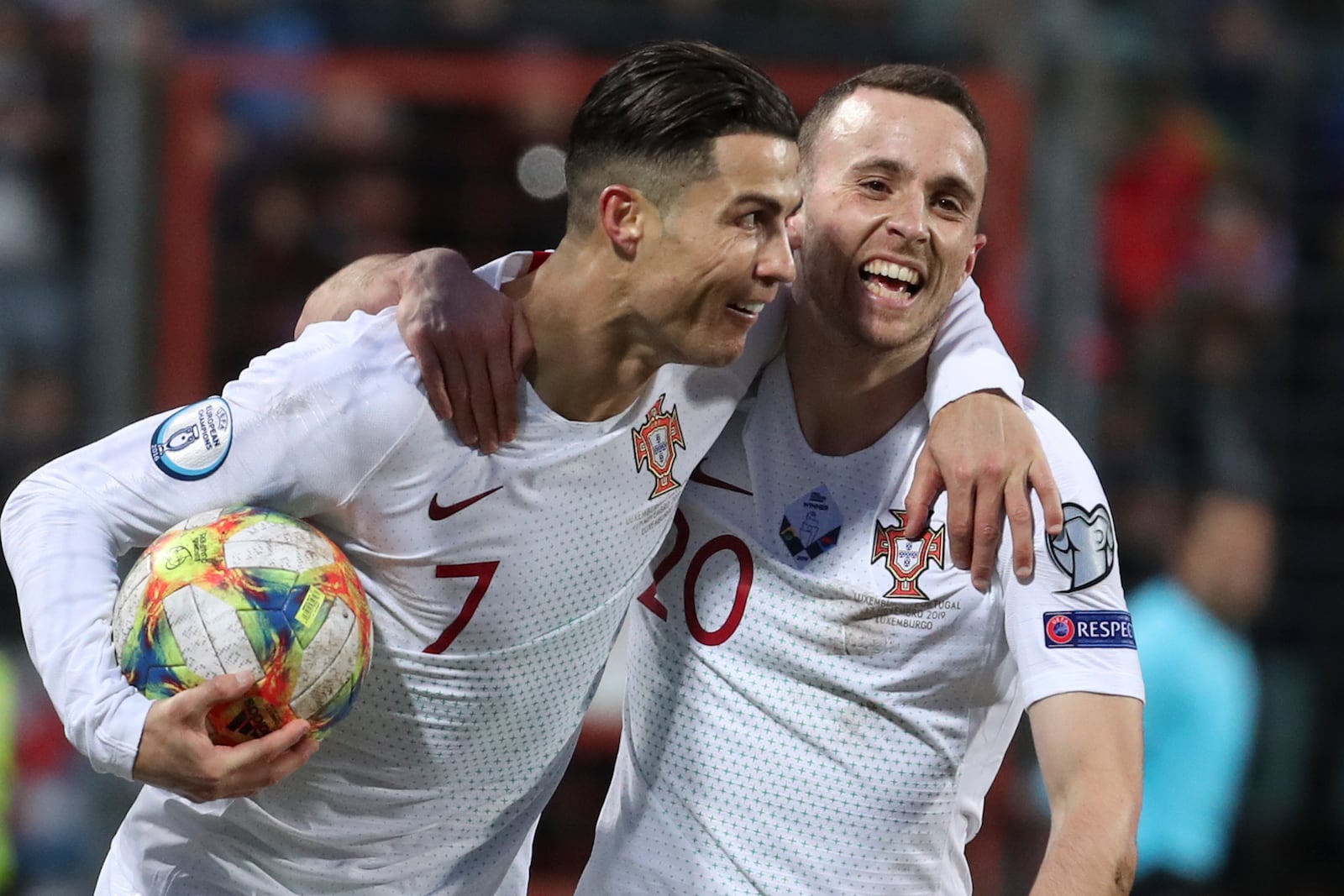 FILE - Portugal's Cristiano Ronaldo, left, celebrates with his teammate Diogo Jota after he scored his side's second goal during the Euro 2020 group B qualifying soccer match between Luxembourg and Portugal at the Josy Barthel stadium in Luxembourg, Sunday, Nov. 17, 2019. (AP Photo/Francisco Seco, File)