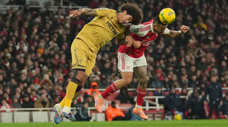 Crystal Palace's Chris Richards, left, and Arsenal's Gabriel Jesus jump for the ball during the English Football League Cup quarter-final soccer match between Arsenal and Crystal Palace in London, Tuesday, Dec. 23, 2025. (AP Photo/Kin Cheung)