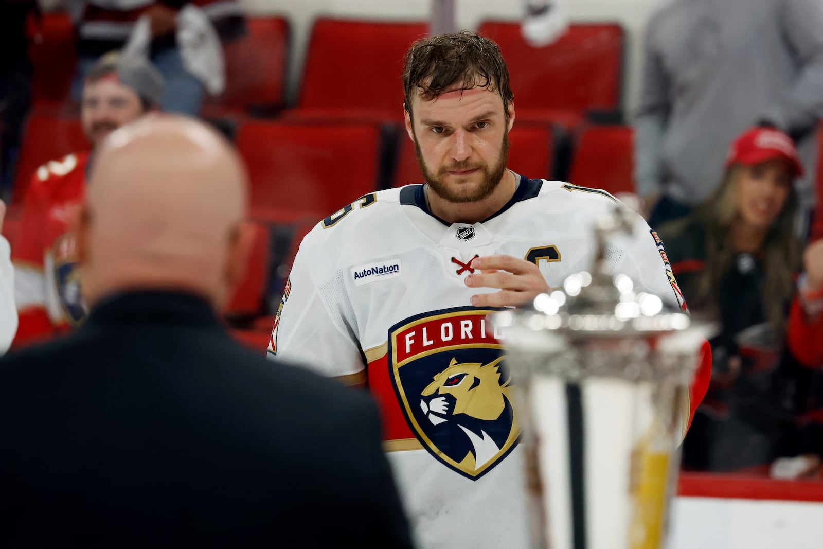 Florida Panthers' Aleksander Barkov (16) skates over to accept the Prince of Wales Trophy following Game 5 of the NHL hockey Stanley Cup Eastern Conference finals against the Carolina Hurricanes in Raleigh, N.C., Wednesday, May 28, 2025. (AP Photo/Karl DeBlaker)