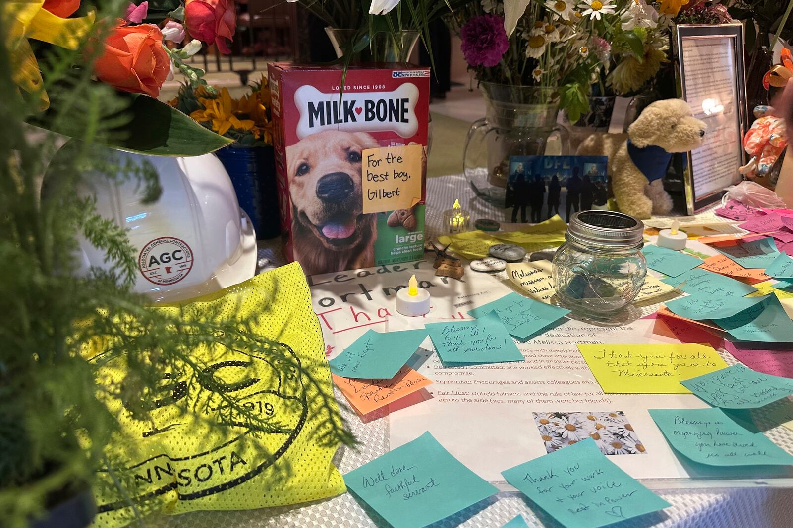 Amid the flowers and other mementos left in honor of former Minnesota House Speaker Melissa Hortman outside the Minnesota House chamber at the state capitol in St. Paul, Minn., on Friday, June 27, 2025, was a box of dog biscuits in honor of her dog, Gilbert, who was seriously injured and had to be put down after Hortman and her husband, Mark, were fatally shot June 14. (AP Photo/Steve Karnowski)