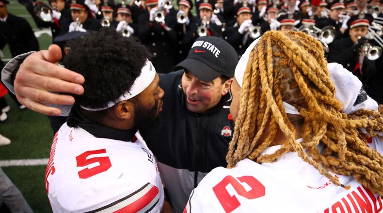 ANN ARBOR, MICHIGAN - NOVEMBER 30: Head coach Ryan Day of the Ohio State Buckeyes celebrates a 57-27 win over the Michigan Wolverines with Chase Young #2 and Baron Browning #5 at Michigan Stadium on November 30, 2019 in Ann Arbor, Michigan. (Photo by Gregory Shamus/Getty Images)