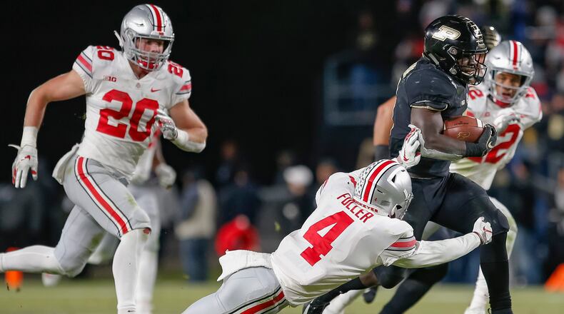 WEST LAFAYETTE, IN - OCTOBER 20: D.J. Knox #1 of the Purdue Boilermakers runs the ball as Jordan Fuller #4 of the Ohio State Buckeyes reaches and misses the tackle at Ross-Ade Stadium on October 20, 2018 in West Lafayette, Indiana. (Photo by Michael Hickey/Getty Images)