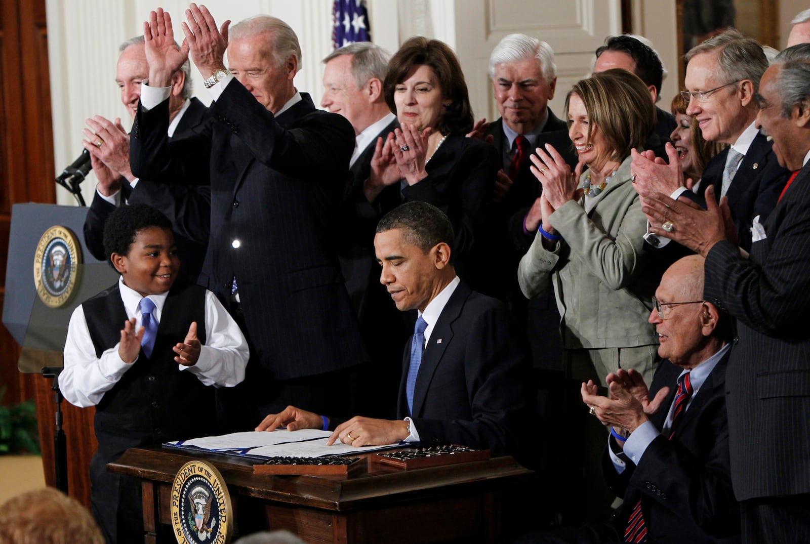 FILE - President Barack Obama is applauded after signing the Affordable Care Act into law in the East Room of the White House in Washington, March 23, 2010. (AP Photo/Charles Dharapak, File)