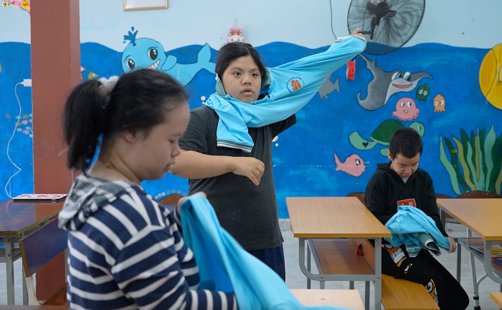 Students put on uniforms at a school for victims of Agent Orange in Da Nang, Vietnam, March 7, 2025. (AP Photo/Hau Dinh)