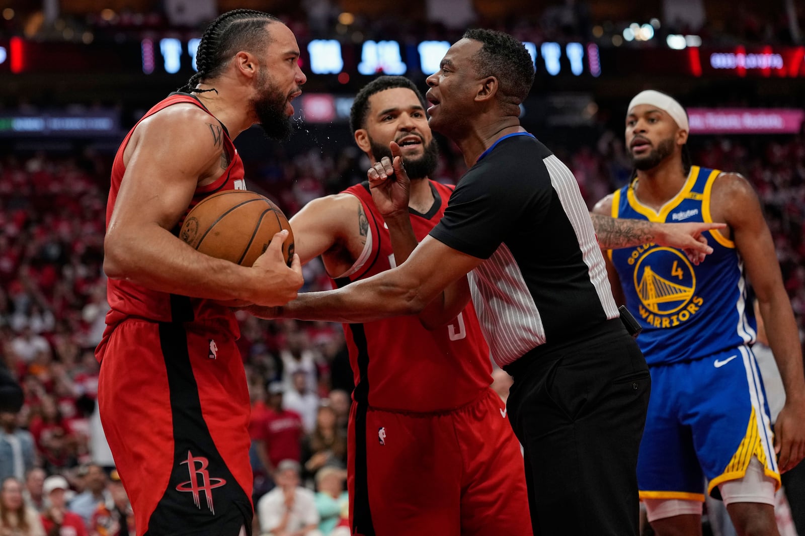 Houston Rockets center Alperen Sengun, left, argues with the referee during the second half of Game 5 of an NBA basketball first-round playoff series against the Golden State Warriors, Wednesday, April 30, 2025, in Houston. (AP Photo/David J. Phillip)
