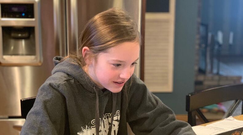 Josie Jennings, a middle school student at Global Impact STEM Academy, partakes in virtual learning from the comfort of her own home during the coronavirus pandemic and subsequent school closures. CONTRIBUTED