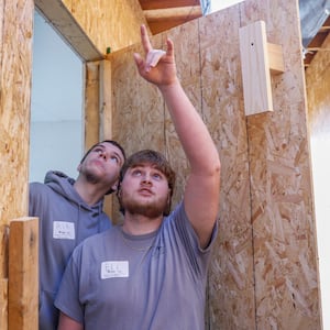Erik Ferrell, left, Eli Koster, students at Springfield-Clark Career Technology Career, lead a tour on Thursday, Feb. 26, 2026, of a modular home built on Springfield-Clark CTC as part of a partnership with the Habitat for Humanity of Greater Dayton and Springfield-Clark CTC. JOSEPH COOKE/STAFF